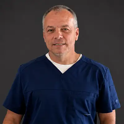 Professional headshot of Dr. Buddy Furqueron, DDS, smiling warmly.