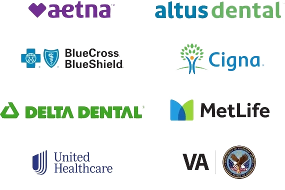 Patient receiving dental care with insurance paperwork on the desk.