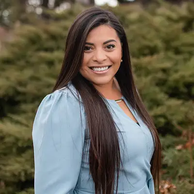 Headshot of Edith, smiling professional with warm demeanor.