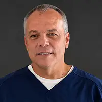 Professional headshot of Dr. Buddy Furqueron, DDS, smiling warmly.
