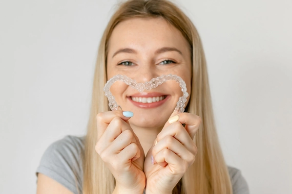 A clean, close-up shot of a woman's glowing, well-rested face in soft, natural light — highlighting smooth skin texture, defined cheekbones, and full lips. The image is elegant and aspirational, conveying the natural, refreshed quality of well-placed filler results.